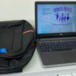 Photo of laptop computer with backpack