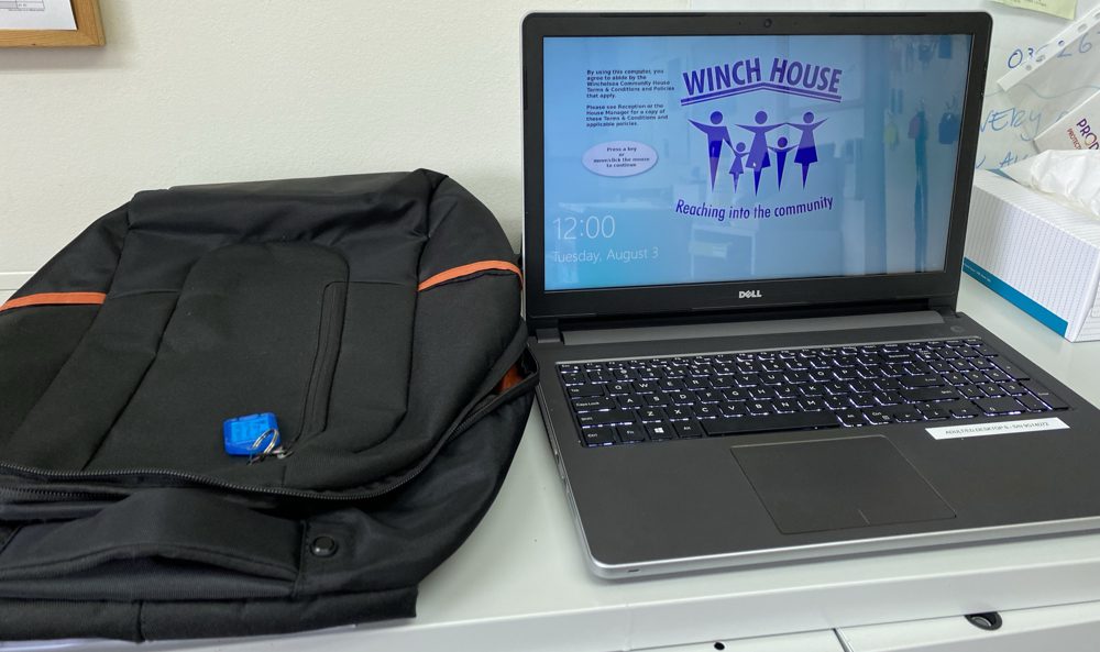 Photo of laptop computer with backpack